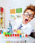 Child in lab coat excitedly pointing at STEM Science Bulletin Board Set With Gear Shaped Cutouts, 40 Pcs Classroom Decorations.