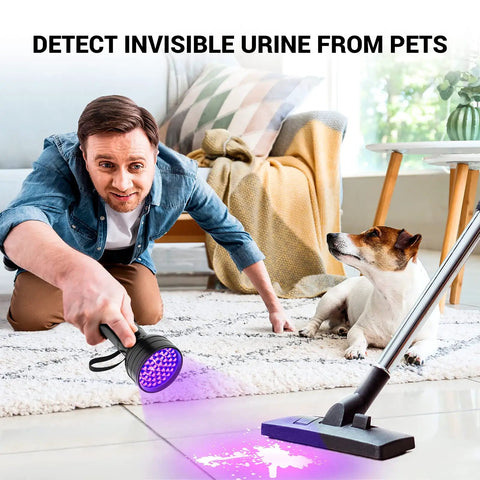 Man using 51 LED UV Black Light Flashlight For Pet Pee Stain Detection And Urine Finder on floor near dog