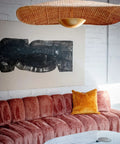 Totally Main Character Energy One Light Pendant Ceiling Light Fifty Two Inches Wide Vintage Gold Leaf Metal Dome Shade hanging above a cozy living room sofa.