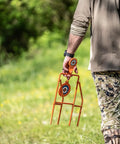 Person carrying Double Paddle Spinner Shooting Target With 3 Inch And 4.5 Inch Spinning Targets in a field