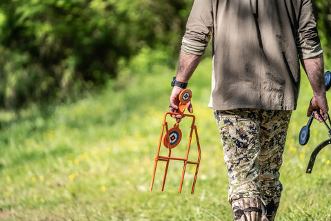 Person carrying Double Paddle Spinner Shooting Target With 3 Inch And 4.5 Inch Spinning Targets in a field