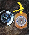 Orienteering Compass Pointer All In One Outdoor Navigation Tool with yellow cord and acrylic base on wooden surface.