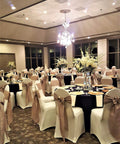 Banquet hall with chairs adorned with 10 Piece Satin Chair Sashes Bows For Wedding Reception And Banquet Decor Universal Back Tie For Chairs