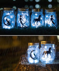 12 Pack Solar Mason Jar Fairy Lights With 30 Warm White LEDs glowing in rain, silhouette designs, ideal for garden decor.