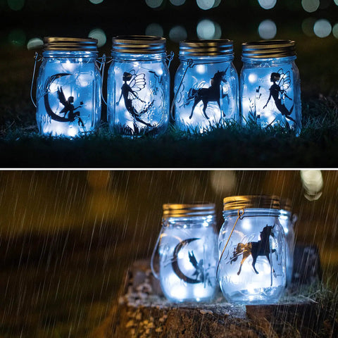 12 Pack Solar Mason Jar Fairy Lights With 30 Warm White LEDs glowing in rain, silhouette designs, ideal for garden decor.