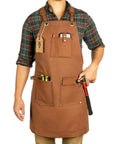 Man wearing Waxed Canvas Work Apron For Men With Pockets, Heavy Duty Carpenter And Grilling Apron, Cross Back Adjustable Fit From M To XXL