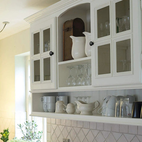White kitchen cupboard with elegant cabinet doors featuring black 1.2 inch knobs from Set Of 30 Round Black Cabinet Knobs 1.2 Inch For Kitchen Cupboard Doors And Drawer Pulls Dope Sleek Solid Stainless Hardware With Screws For Dresser Furniture For Home Improvement And Easy Installation.