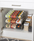 Three Tier Chrome Steel Can Organizer Holds Thirty Six Cans For Pantry Or Cabinet, stored in a white cabinet for organized access.