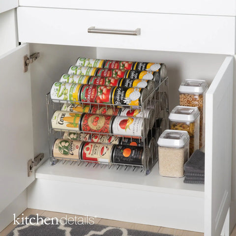 Three Tier Chrome Steel Can Organizer Holds Thirty Six Cans For Pantry Or Cabinet, stored in a white cabinet for organized access.