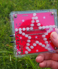 Star Shaped Soldering Practice Kit For Electronics DIY Projects With Colorful LED Flashing And Beep Music Entry Level MCU Training Kit For Beginners Two Sided Wiring Design Creative Present Or Gift in a hand outdoors