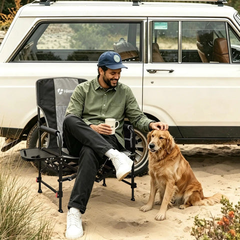 Man sitting in Foldable Camping Director Chair With Adjustable Height, Built Tough Oversized Seat, Side Table, and Storage Pocket