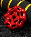 Red Cast Iron Valve Hand Wheel Set, 10 Pack, Heavy Duty Shutoff Handles With Decorative Metal Accents on a dark gravel surface