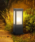 Rock Solid 15.75 Inch Outdoor Bollard Path Lights With Knockout Aluminum Frame And Frosted Glass Shade illuminating garden pathway.