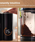 Close-up of Legit Precision Coffee Grinder with Built in Dosing Scale measuring 15g of coffee grounds, matte black design.
