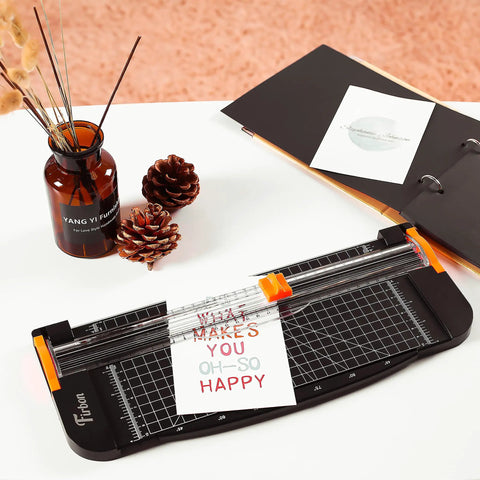 12 Inch Titanium A4 Paper Cutter With Automatic Safety Guard And Side Ruler on desk with pinecones and paper