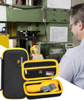 Front view of Aproca case for Fluke infrared thermometer accessories; black with yellow trim, open to reveal pockets.