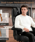 Big And Tall Office Chair For Desk Use With Soft Adjustable Armrests And Comfy Ergonomic High Back With Lumbar Support And Built In Footrest PU Leather Executive Computer Chair In Black with dual-layer support and a man sitting.
