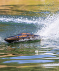 Heatwave Recoil 2 V2 26 Self Righting Brushless RTR RC Boat skimming across a lake, showcasing speed and splash dynamics.