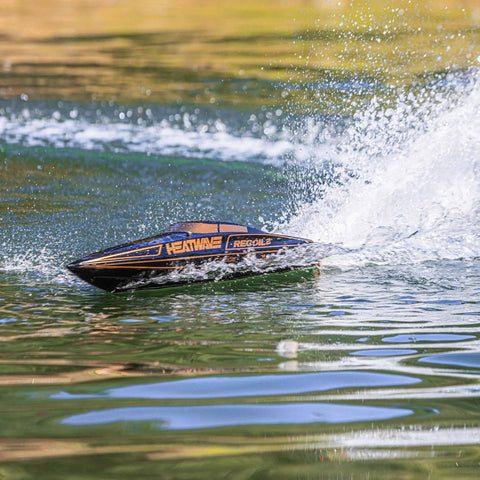 Heatwave Recoil 2 V2 26 Self Righting Brushless RTR RC Boat skimming across a lake, showcasing speed and splash dynamics.