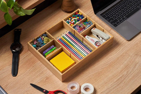 Bamboo Desk Drawer Organizer With Adjustable Dividers For Office And Vanity Anti Slip Storage Tray Keeps Pens Makeup And Small Tools Neat 12 By 9 Inches filled with colorful stationery on a desk.