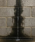 Water flowing down a concrete masonry wall, highlighting the need for Hardcore White Basement Sealer For Concrete And Masonry Walls Block Ten Psi Negative Hydrostatic Pressure Low Voc Earth Safe Formula Super Easy Brush Roll Or Spray Application In Five Gallon Bucket.