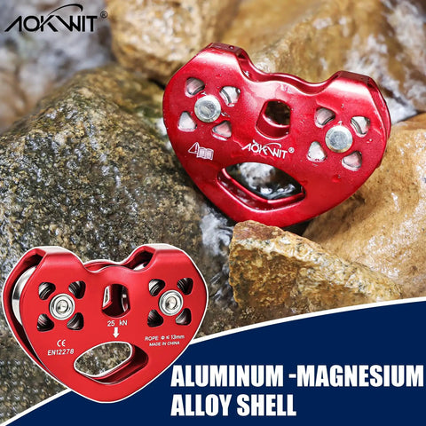 Red Zipline Pulley 25KN Aluminum Alloy Trolley With Stainless Steel Bearings on rocky surface, featuring holes and logo engraving.