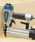 Rock Solid 18 Gauge 2 Inch Brad Nailer Kit positioned beside a wooden box, showcasing toolless jam clearing and rubber nose.