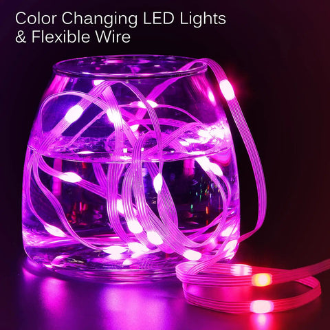 RGB LED Curtain Lights 300 LEDs 10 Ft By 10 Ft Color Changing String Fairy Lights coiled in a glass vase, glowing pink.