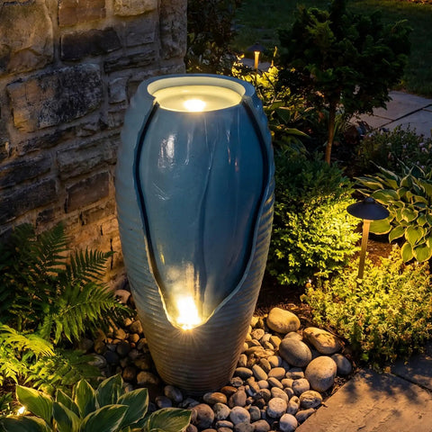 32 Inch Outdoor Jar Water Fountain With LED Lights, Vintage Blue Cracked Jar Design, cascading waterfall in garden setting.