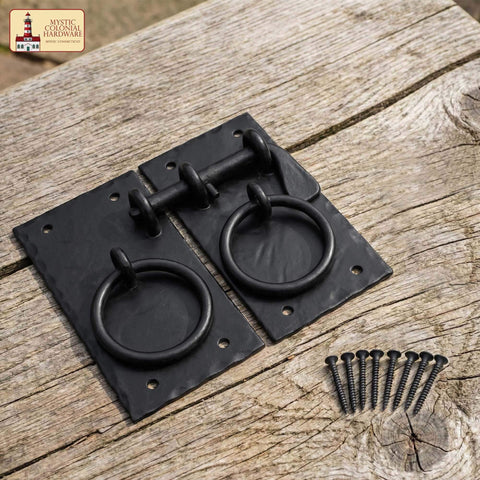 Colonial Style Iron Gate Latch Black Flip Latch Heavy Duty Cast Iron Drop Latch for barns, sheds, cabinets, shutters shown on wood surface