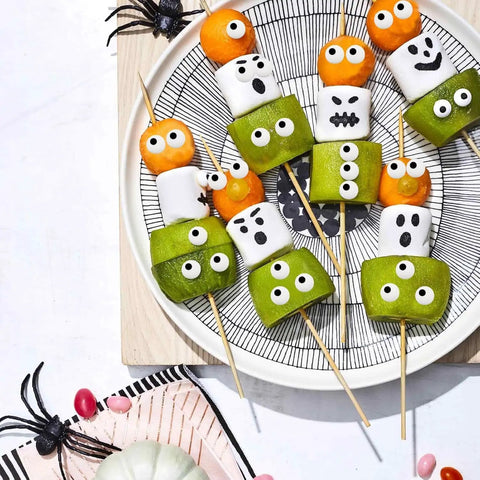 Plate of snacks with Big Edible Candy Eyeballs 10 Mm For Bold Decorating Pack Of 2 Jars 3 Oz Each Total 6 Oz arranged creatively.