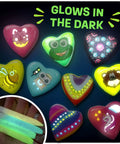 Glow In The Dark Heart Rock Painting Kit For Kids Ages 4 To 12, STEM Craft Set With Puffy Paint Stickers Gems And Paints, showing glowing rocks and paints under dark lighting.