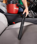 Person using a 1.5 Gallon 2.0 Peak Wet Dry Vacuum For Quick Cleanups At Home, Garage, Or Vehicle on car seat