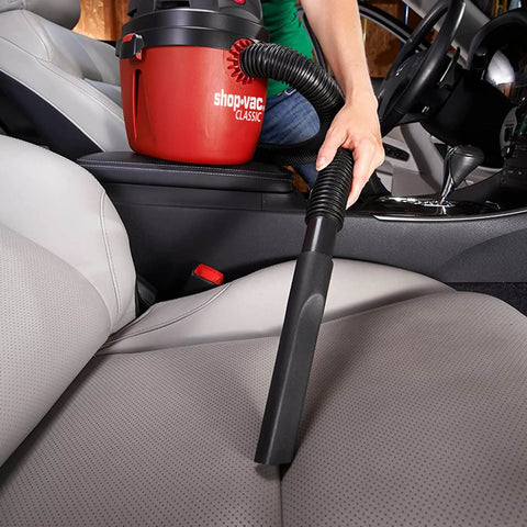 Person using a 1.5 Gallon 2.0 Peak Wet Dry Vacuum For Quick Cleanups At Home, Garage, Or Vehicle on car seat