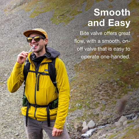 Osprey Hydraulics bite valve replacement; front view of a hiker in a yellow jacket outdoors.