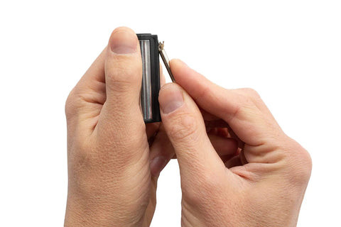 Hands holding a Permanent Fire Starter 5 Pack, Waterproof Metal Keychain Lighter For Camping Stoves Grills And Emergencies, Unlimited Strikes Anywhere.