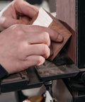 User sanding a piece of wood on a Heavy Duty 6 By 48 Inch Belt And 12 Inch Disc Sander With Closed Stand.