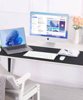 Large Desk Pad 47.2 Inch By 17 Inch Leather Desk Pad Protector with Natural Cork and PU Leather in black on office desk.