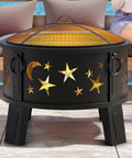26 Inch Outdoor Fire Pit With Grill, Mesh Spark Screen And Poker in a garden setting, featuring star and moon cutouts