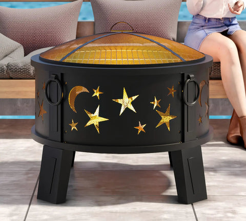 26 Inch Outdoor Fire Pit With Grill, Mesh Spark Screen And Poker in a garden setting, featuring star and moon cutouts