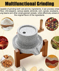 Stone Grain Mill Grinder For Home Use With Hand Crank And Solid Wood Base, Natural Granite Stone Mill surrounded by various grains and spices.