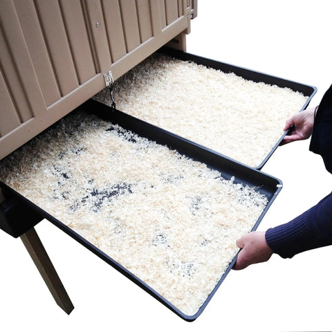 Hands pulling out litter trays from Snap Lock Large Chicken Coop for Backyards, spacious hen house with removable dividers.