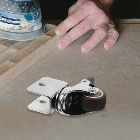 Rugged Swivel Furniture Casters With Gliding Silent Rollers And Tough Round Plates Built For Cabinets Drawers And Office Gear On Hardwood Floors Featuring Quick Fit Brake Clamps For Any Space mounted on a wood surface.