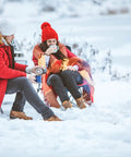 Two people seated outdoors near a GS4200EP 13,000 BTU Propane Tank Top Heater in snowy landscape with camp chairs and blanket.