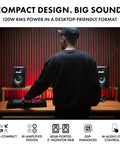 Person using BX5BT 5 Inch Desktop Studio Monitor Speakers With DSP And Bluetooth App Control, 240W Bi-Amped Power in home studio