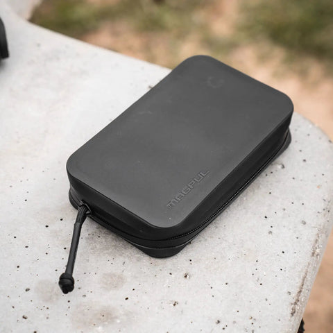 Black DAKA Utility Organizer Compact SemiRigid Case For Gear And Electronics on outdoor surface