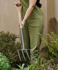 Person using Carbon Steel Digging Fork With Ash Wood YD Handle For Tough Garden Jobs Heavy Duty Solid Forged Head