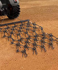 Heavy-Duty Chain Harrow with 69 Teeth attached to ATV. Drag Harrow For Tractor ATV And UTV Use Heavy Duty Chain Harrow With 69 Teeth 4 Ft By 4 Ft A True Workhorse For Soil Prep Seeding Lawn Smoothing Landscaping And Gravel Driveway Maintenance.