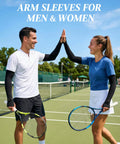 Keep Your Arms Shaded And Locked In With These Adjustable UV Sun Sleeves Featuring A Handy Watch Cutout Thumb Loop And Anti Roll Closure For Effortless Cooling On Every Road Journey. Two people wearing black UV sun sleeves on a tennis court.