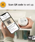 Person holding a smartphone scanning QR code on WiFi Water Leak Detector and Freeze Alarm with Alexa Compatibility, Smart Home Leak Sensor